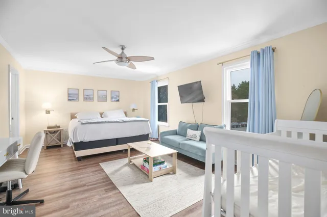 a bedroom with furniture and a large window