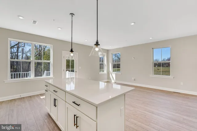 a kitchen with stainless steel appliances granite countertop a sink a window and a counter top space