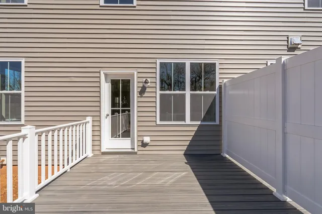 a view of a house with wooden deck