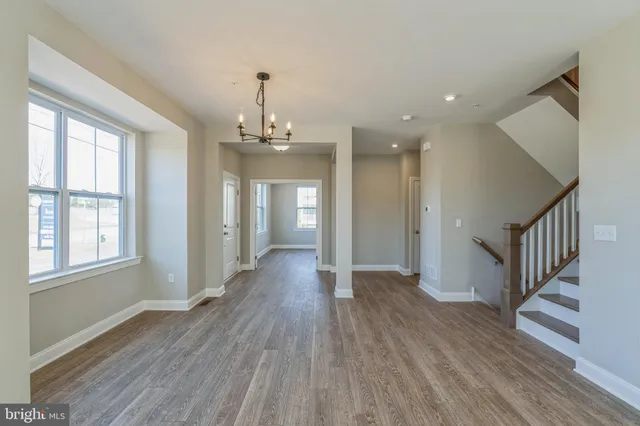 a view of a room with wooden floor and windows