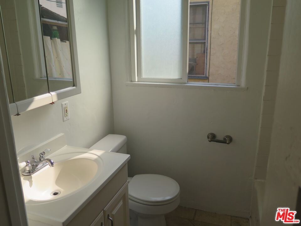 2128 20th Street, Unit B Santa Monica, CA 90405 - Photo 15 of 22 a bathroom with a sink toilet and mirror