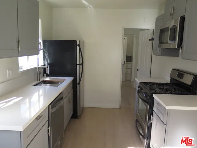 a kitchen with a sink and a refrigerator
