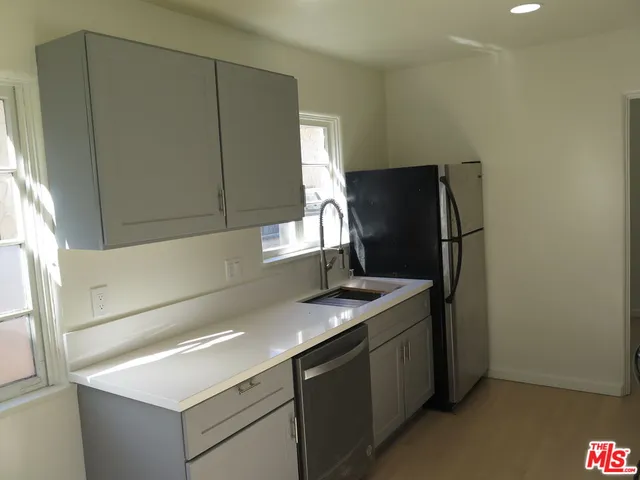 a kitchen with stainless steel appliances a stove microwave and refrigerator
