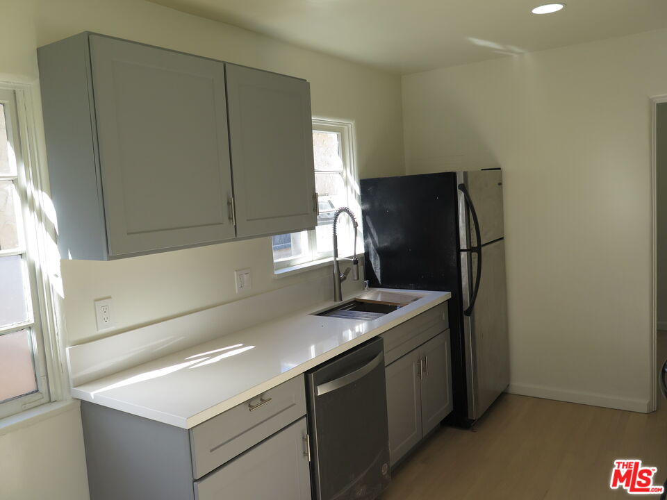 2128 20th Street, Unit B Santa Monica, CA 90405 - Photo 7 of 22 a kitchen with a sink and a refrigerator