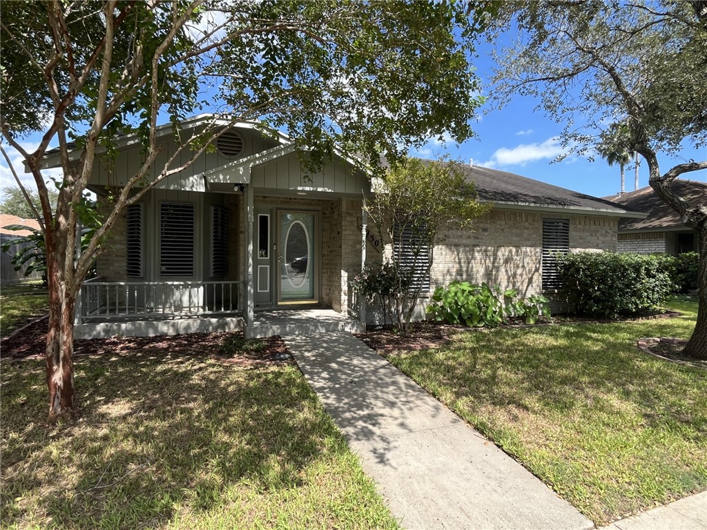 a front view of a house with a garden