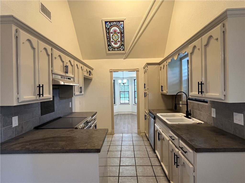 2930 River Crest Road Corpus Christi, TX 78415 - Photo 13 of 27 a kitchen with stainless steel appliances granite countertop a sink stove and cabinets