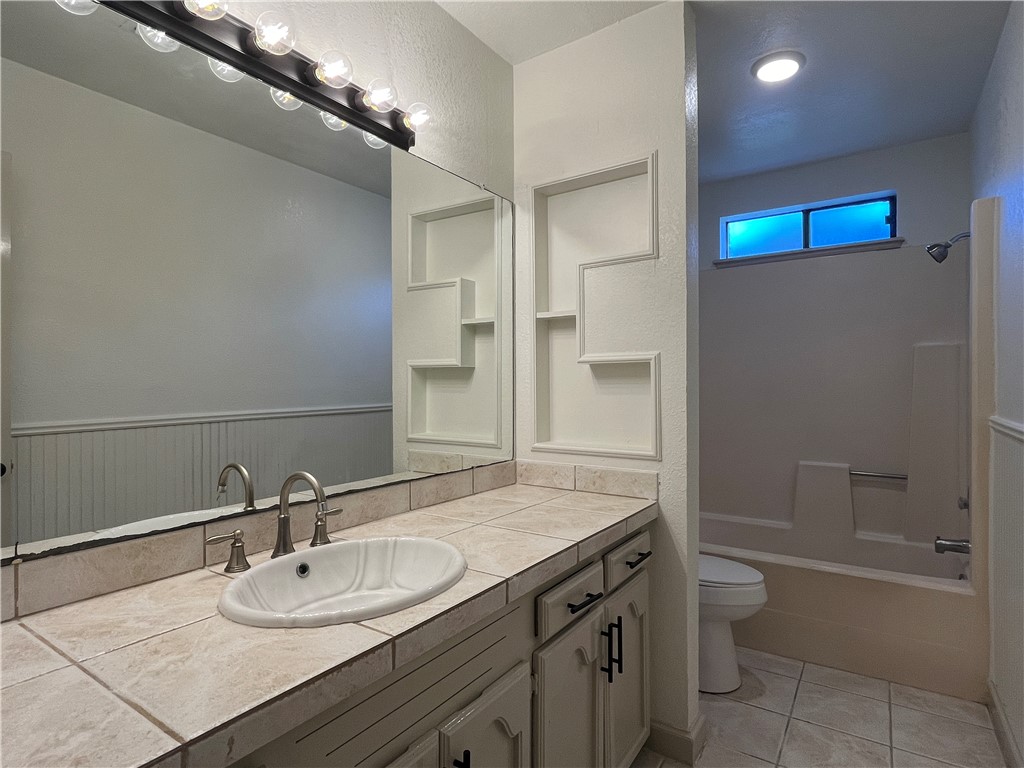 2930 River Crest Road Corpus Christi, TX 78415 - Photo 20 of 27 a bathroom with a granite countertop sink toilet and shower