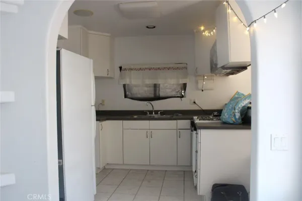 a kitchen with stainless steel appliances granite countertop a sink a stove and a refrigerator