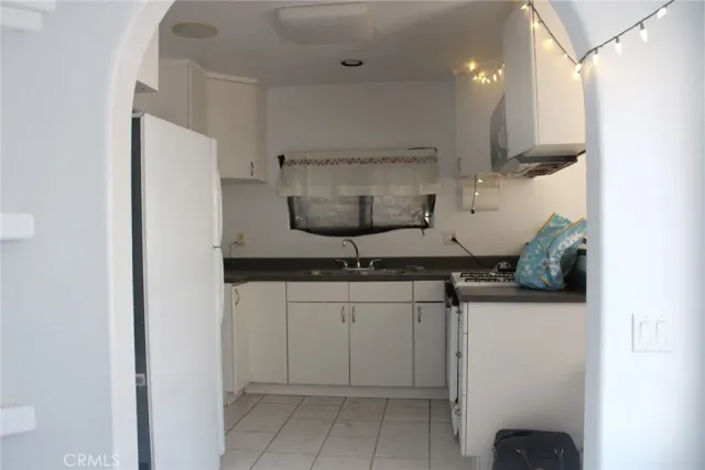 a kitchen with stainless steel appliances granite countertop a sink a stove and a refrigerator