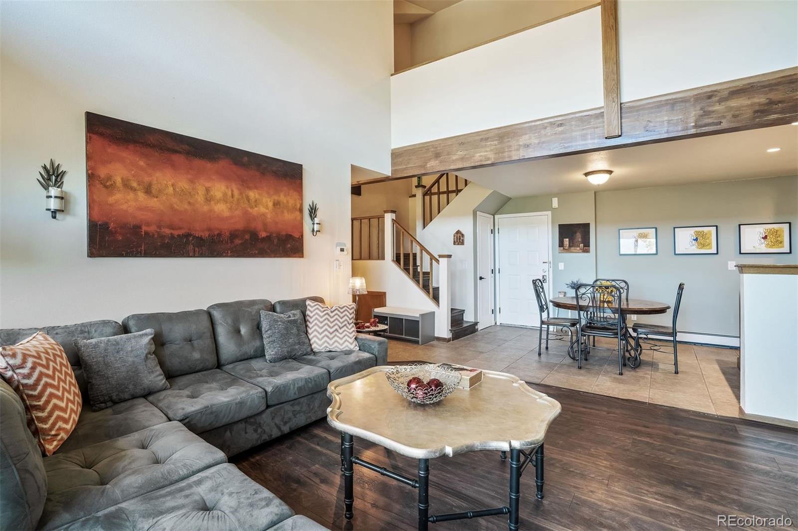 89310 Ryan Gulch Road, Unit 403 Silverthorne, CO 80498 - Photo 12 of 40 a living room with furniture and wooden floor