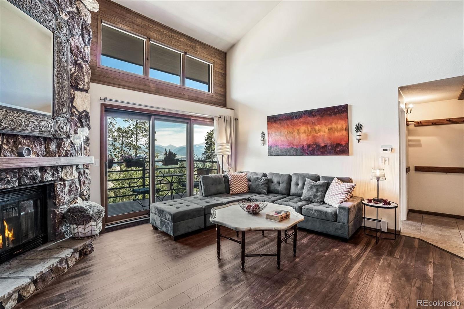 89310 Ryan Gulch Road, Unit 403 Silverthorne, CO 80498 - Photo 14 of 40 a living room with furniture and a fireplace