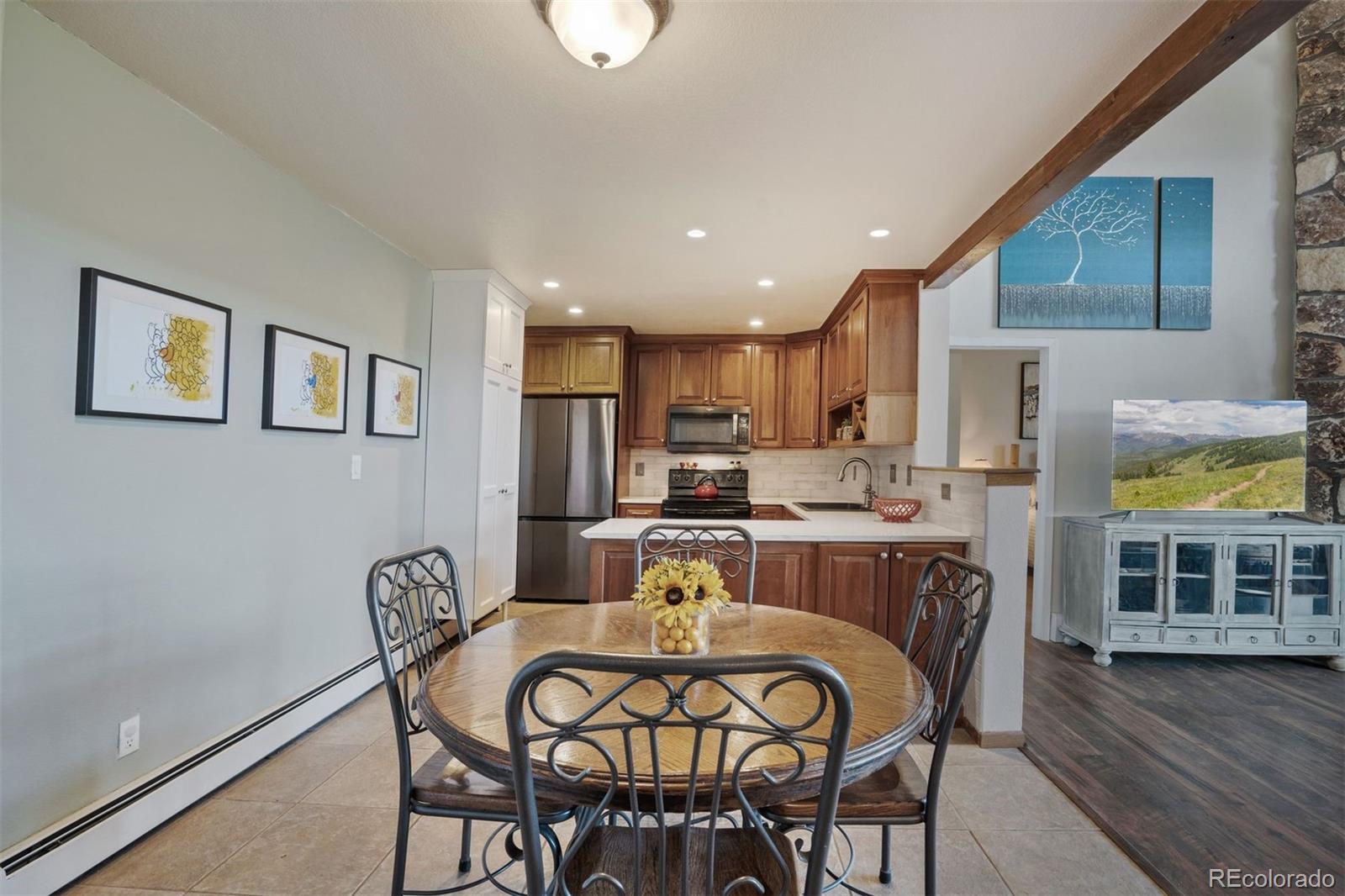 89310 Ryan Gulch Road, Unit 403 Silverthorne, CO 80498 - Photo 15 of 40 a view of a dining room with furniture wooden floor and front door