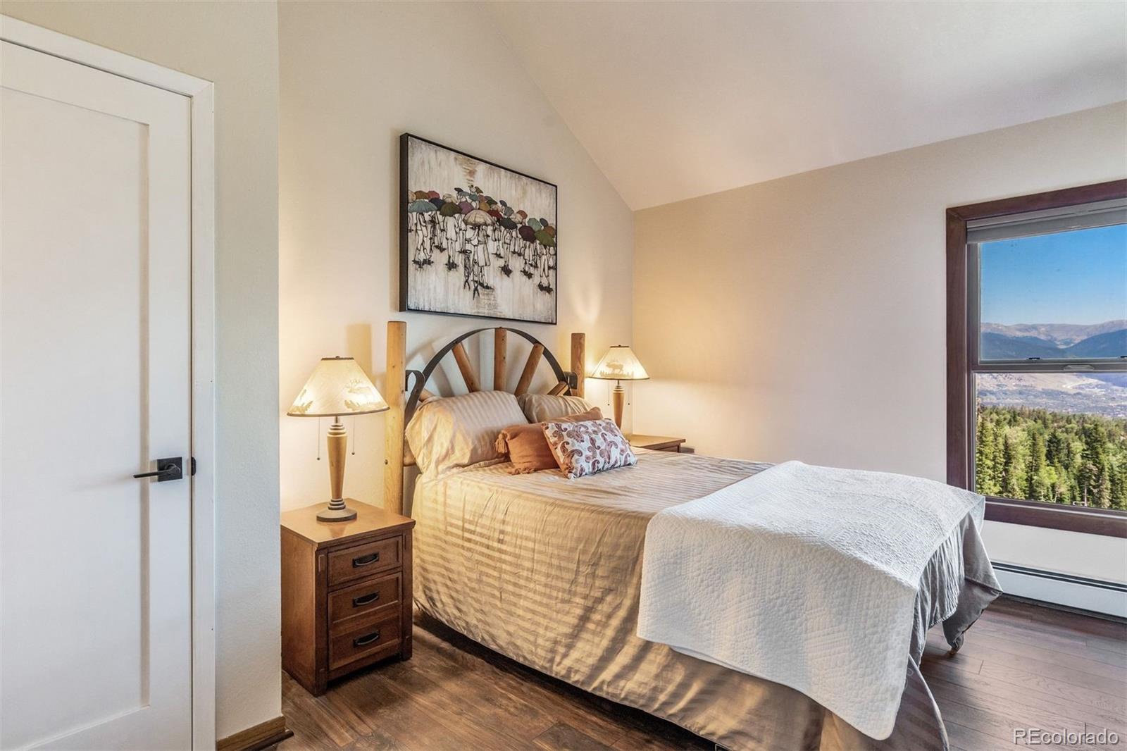 89310 Ryan Gulch Road, Unit 403 Silverthorne, CO 80498 - Photo 17 of 40 a bedroom with a bed and a window