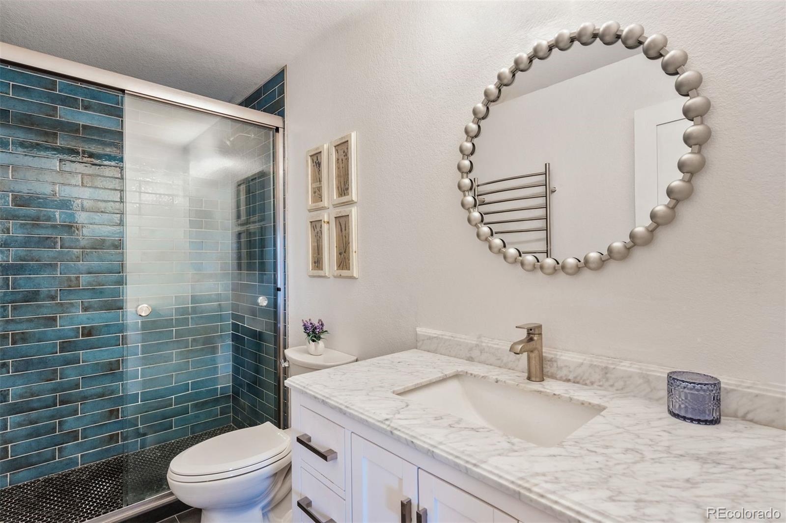 89310 Ryan Gulch Road, Unit 403 Silverthorne, CO 80498 - Photo 18 of 40 a bathroom with a granite countertop sink mirror vanity and toilet