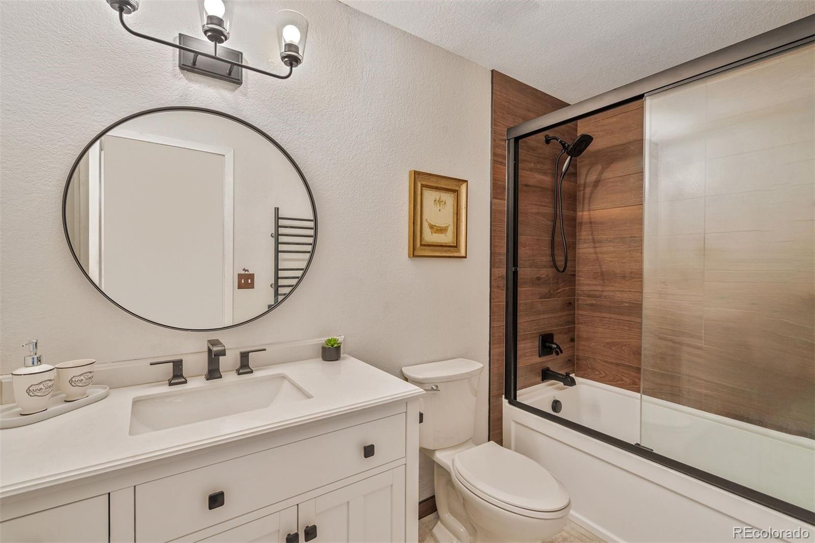 89310 Ryan Gulch Road, Unit 403 Silverthorne, CO 80498 - Photo 21 of 40 a bathroom with a sink a toilet and a mirror