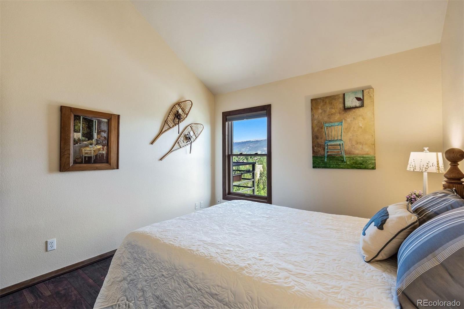 89310 Ryan Gulch Road, Unit 403 Silverthorne, CO 80498 - Photo 22 of 40 a bedroom with a bed and a window