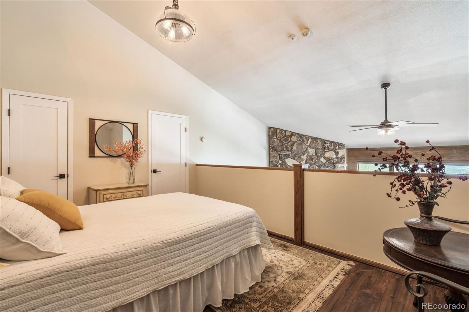 89310 Ryan Gulch Road, Unit 403 Silverthorne, CO 80498 - Photo 23 of 40 a bedroom with a bed and a potted plant on the dresser