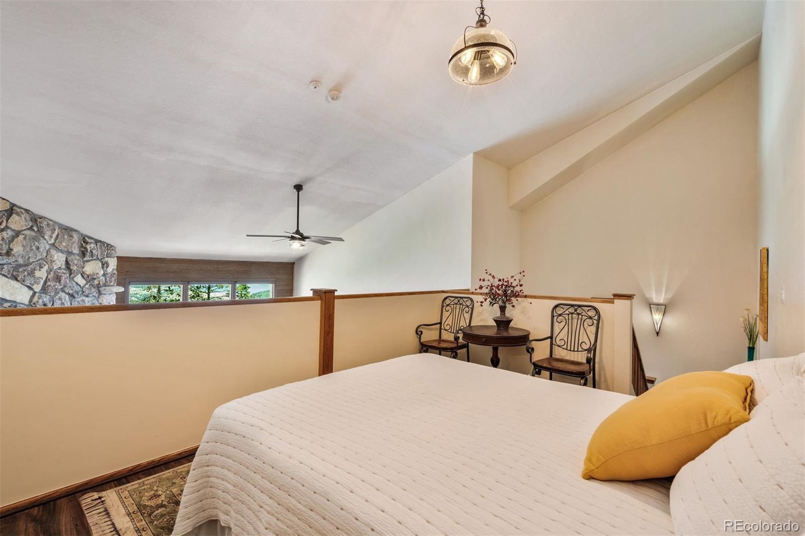 89310 Ryan Gulch Road, Unit 403 Silverthorne, CO 80498 - Photo 24 of 40 a bedroom with a bed and ceiling fan