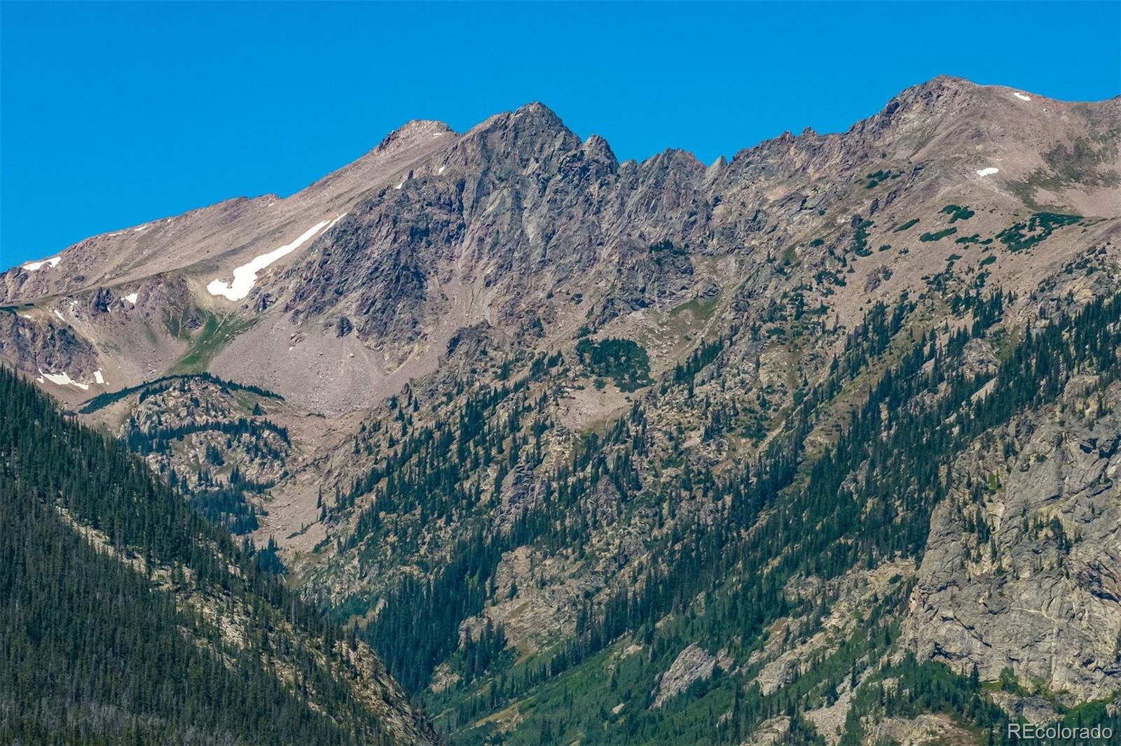 89310 Ryan Gulch Road, Unit 403 Silverthorne, CO 80498 - Photo 3 of 40 a view of a large building with a mountain in the background