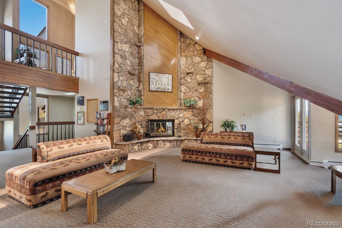 89310 Ryan Gulch Road, Unit 403 Silverthorne, CO 80498 - Photo 38 of 40 a living room with furniture and a fireplace
