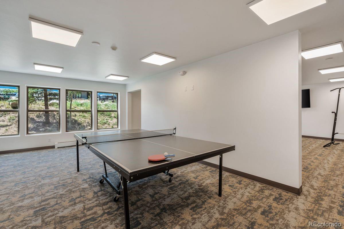 89310 Ryan Gulch Road, Unit 403 Silverthorne, CO 80498 - Photo 39 of 40 a living room with pool table and windows