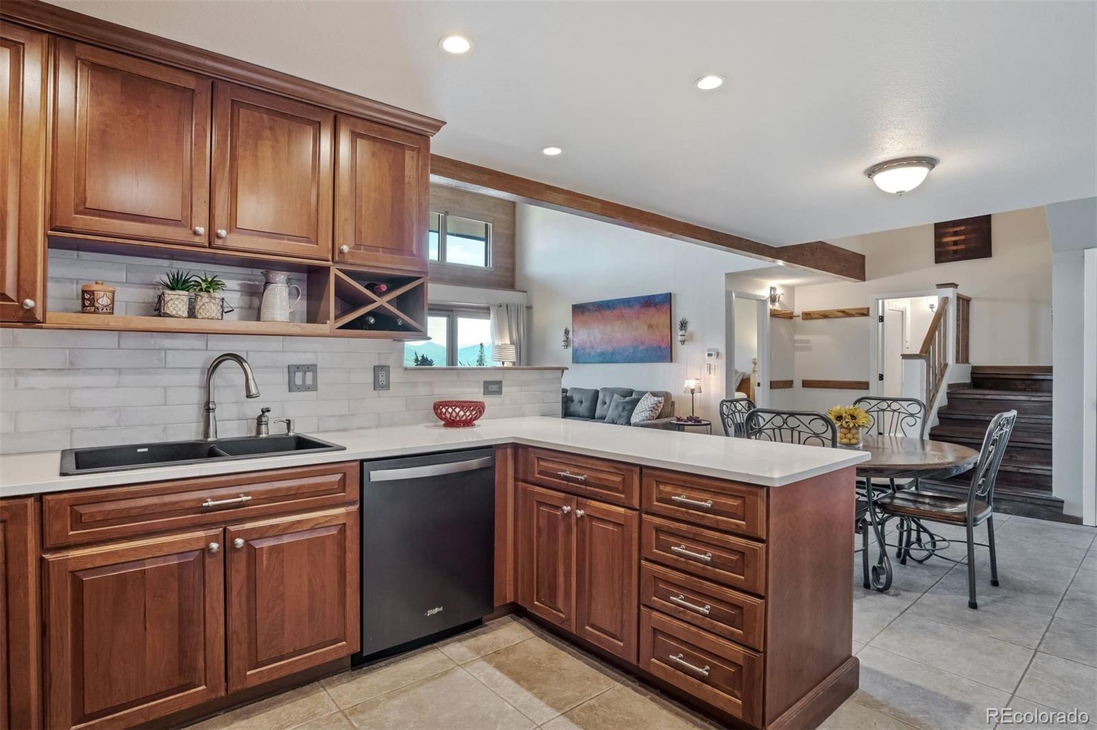 89310 Ryan Gulch Road, Unit 403 Silverthorne, CO 80498 - Photo 4 of 40 a kitchen with stainless steel appliances granite countertop a sink and cabinets