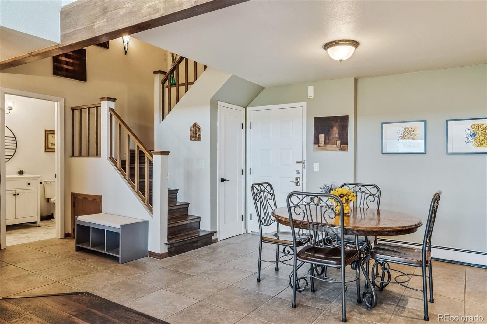 89310 Ryan Gulch Road, Unit 403 Silverthorne, CO 80498 - Photo 8 of 40 a view of a dining room with furniture and a chandelier