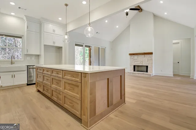 a view of a kitchen with wooden cabinet and a fireplace