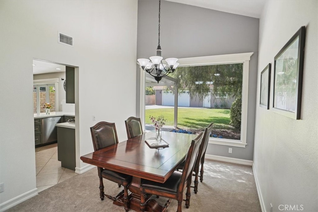27763 Wakefield Road Castaic, CA 91384 - Photo 12 of 39 a dining room with furniture a chandelier and wooden floor