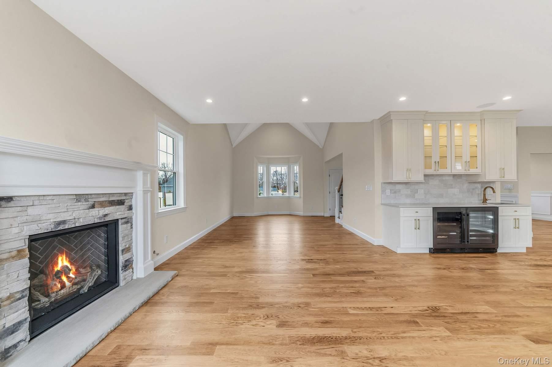 457 Pond Path East Setauket, NY 11733 - Photo 13 of 47 a view of an empty room and a fireplace