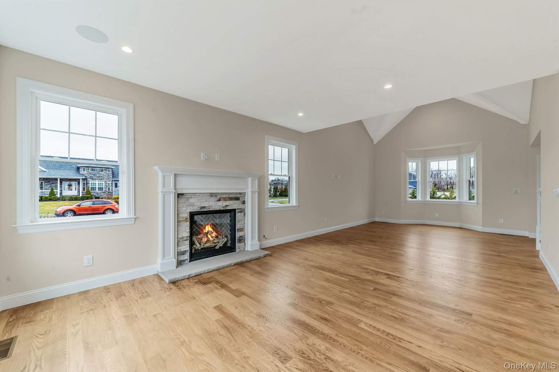 457 Pond Path East Setauket, NY 11733 - Photo 14 of 47 an empty room with windows and fireplace