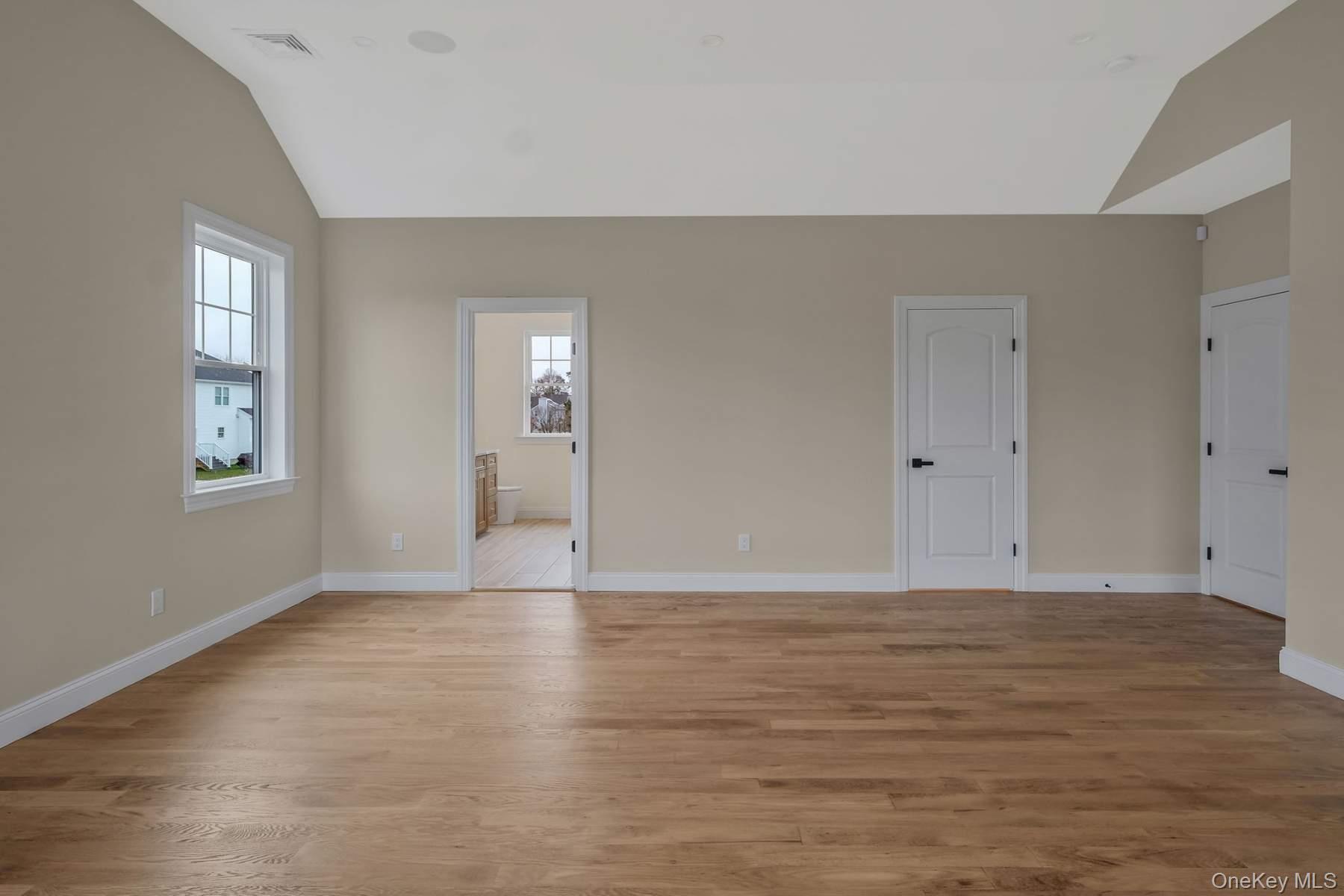 457 Pond Path East Setauket, NY 11733 - Photo 18 of 47 a view of an empty room with window and wooden floor