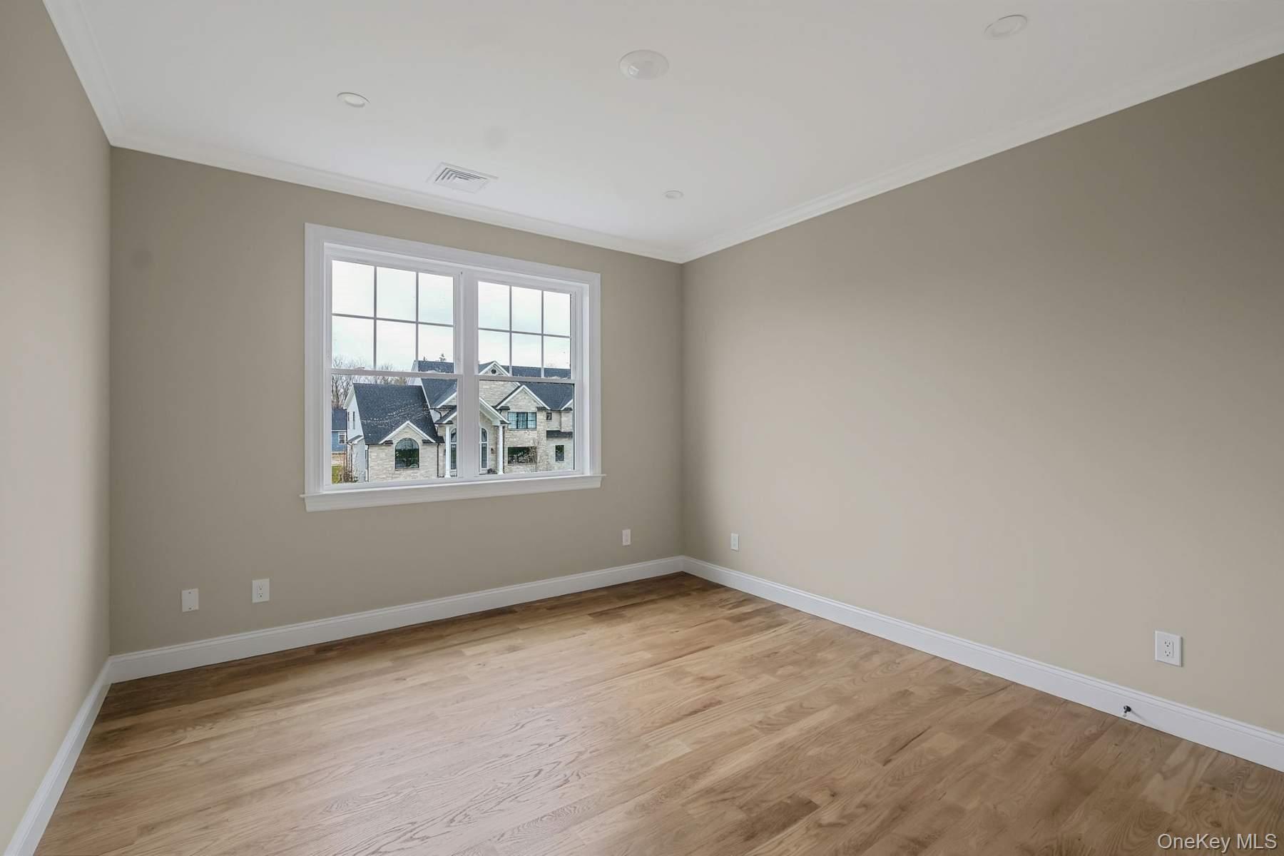 457 Pond Path East Setauket, NY 11733 - Photo 25 of 47 wooden floor in an empty room with a window