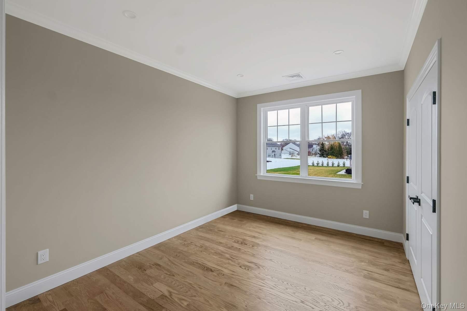 457 Pond Path East Setauket, NY 11733 - Photo 26 of 47 an empty room with windows