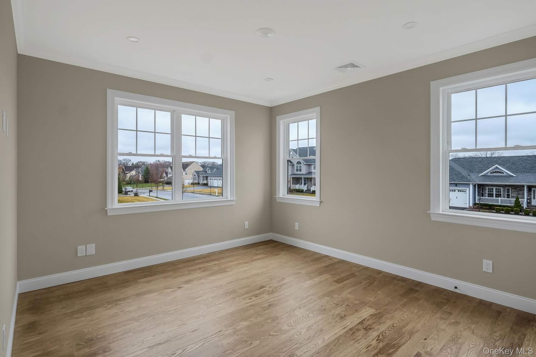 457 Pond Path East Setauket, NY 11733 - Photo 27 of 47 an empty room with windows