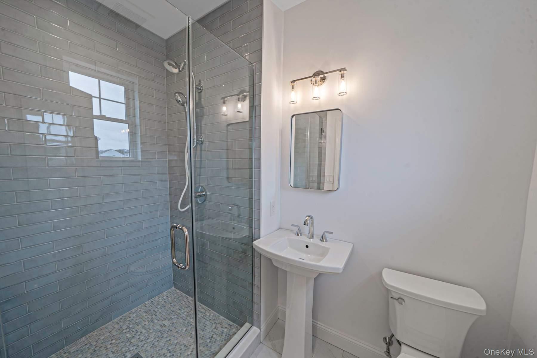 457 Pond Path East Setauket, NY 11733 - Photo 29 of 47 a bathroom with a sink toilet and shower