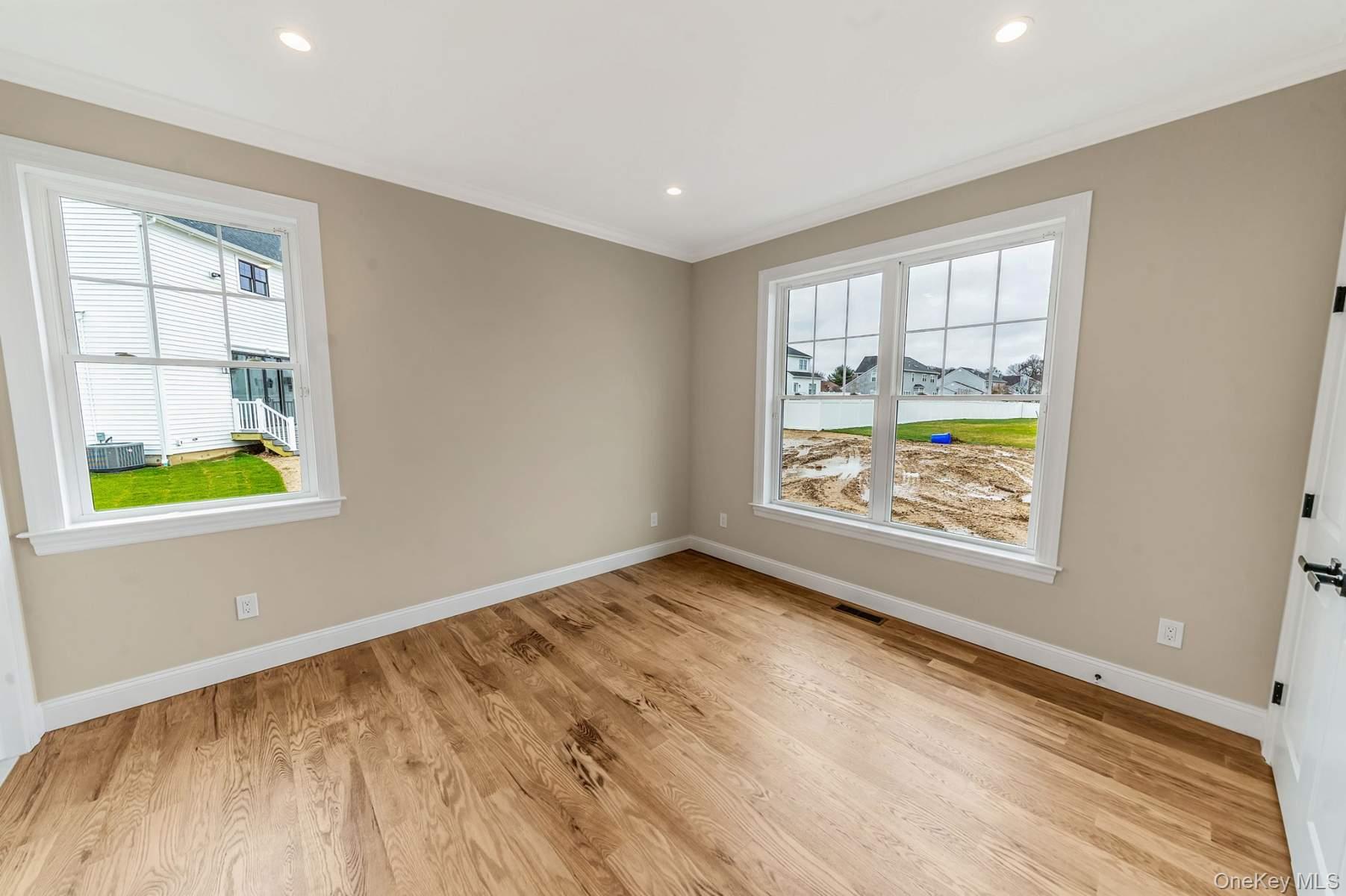 457 Pond Path East Setauket, NY 11733 - Photo 32 of 47 an empty room with windows