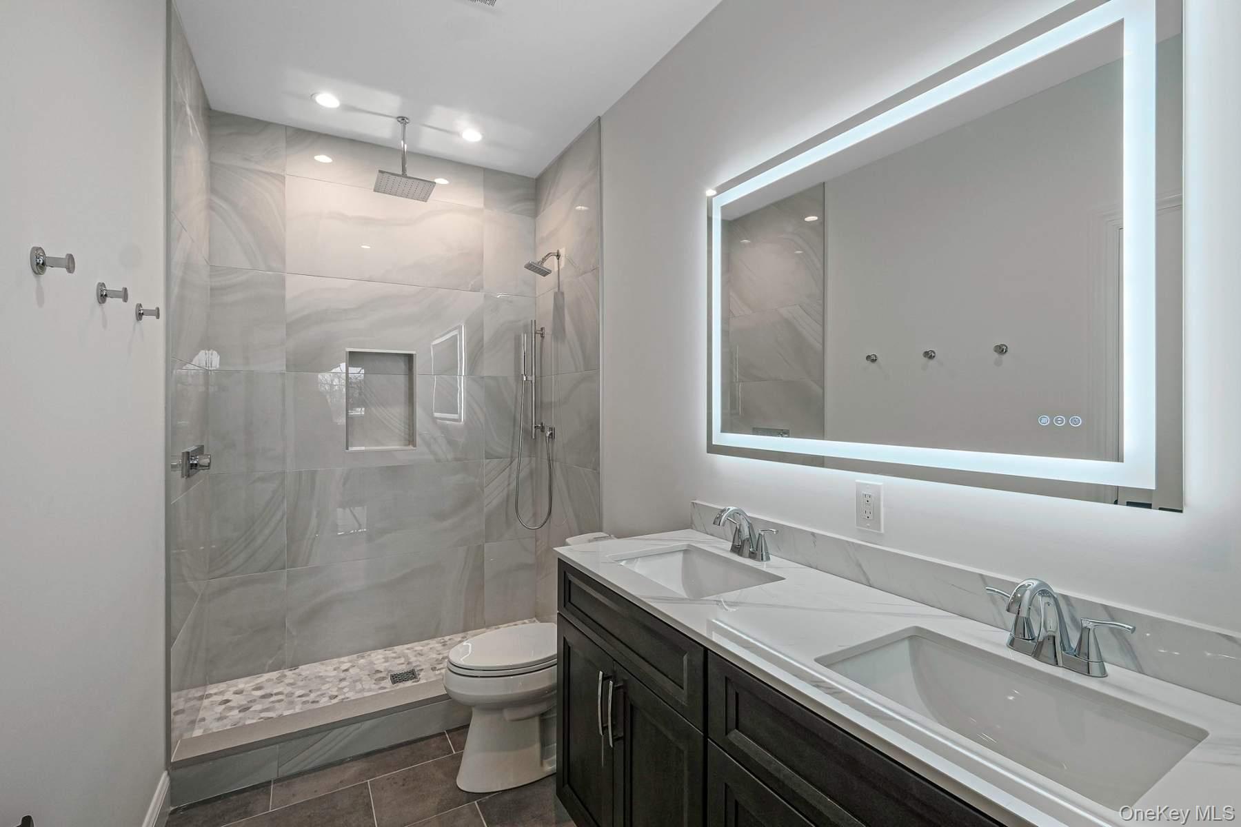 457 Pond Path East Setauket, NY 11733 - Photo 34 of 47 a bathroom with a granite countertop sink a toilet a shower and a mirror