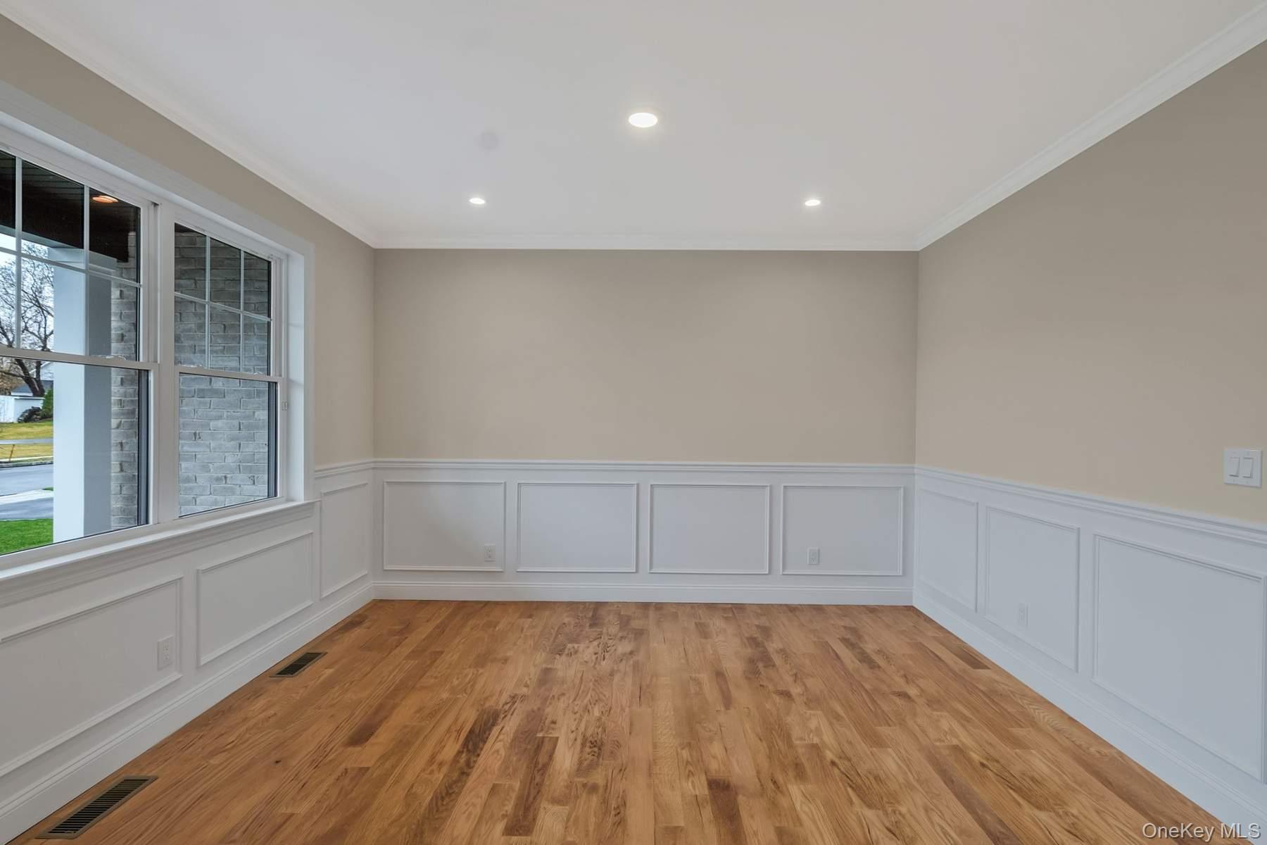 457 Pond Path East Setauket, NY 11733 - Photo 5 of 47 a view of empty room with wooden floor and fan