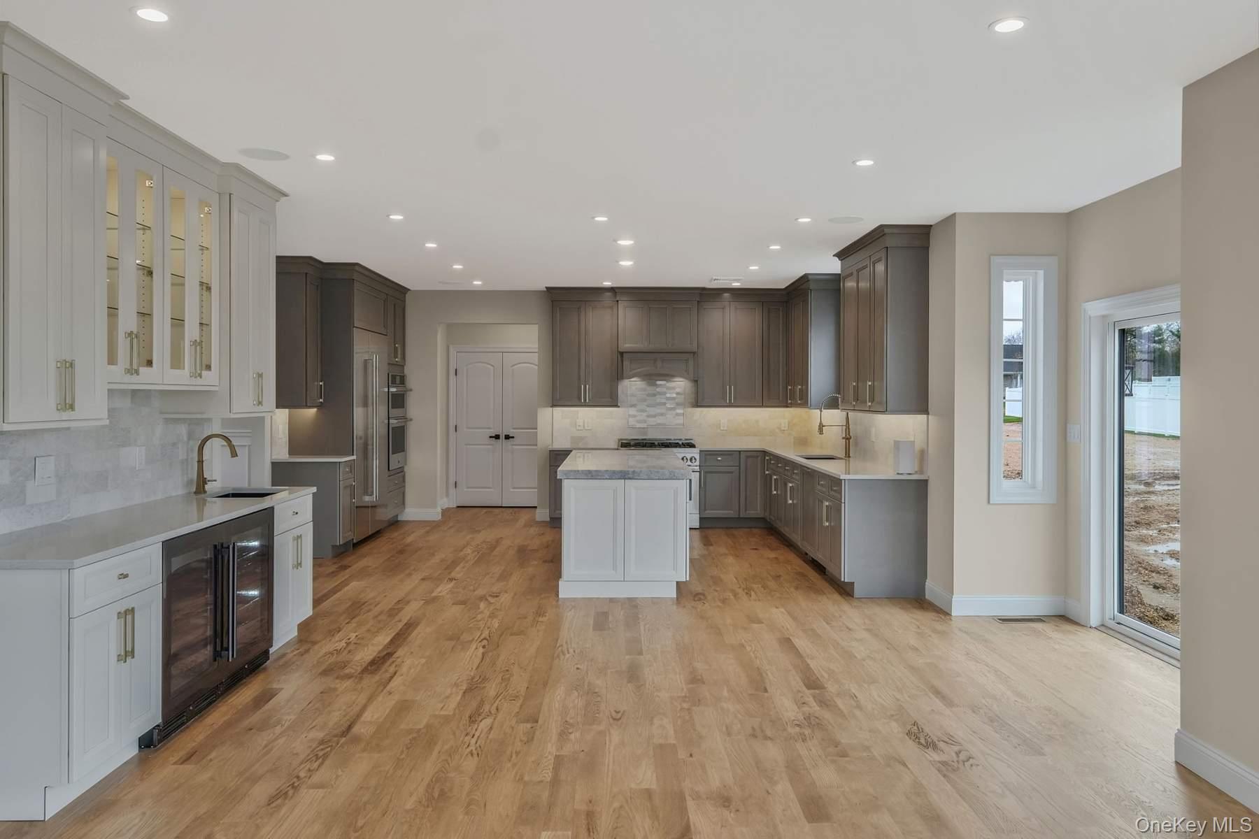 457 Pond Path East Setauket, NY 11733 - Photo 7 of 47 a large kitchen with stainless steel appliances lots of counter top space and cabinets