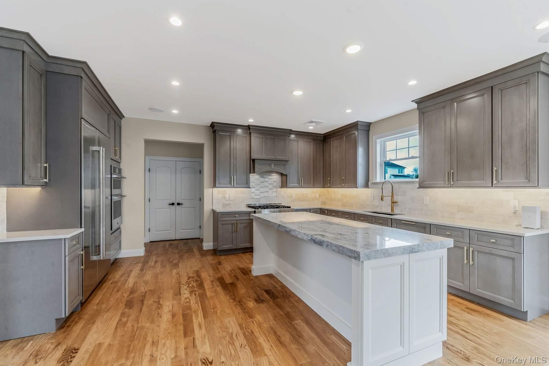 457 Pond Path East Setauket, NY 11733 - Photo 8 of 47 a kitchen with stainless steel appliances granite countertop a sink stove and refrigerator