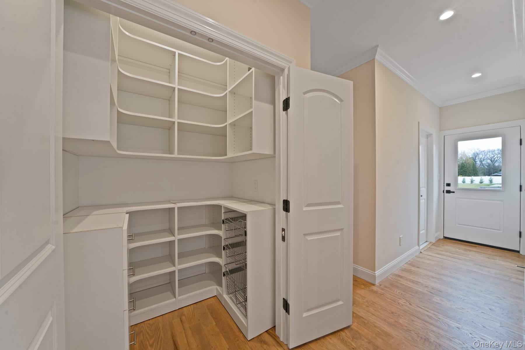 457 Pond Path East Setauket, NY 11733 - Photo 10 of 47 a view of an empty room with wooden floor and a window