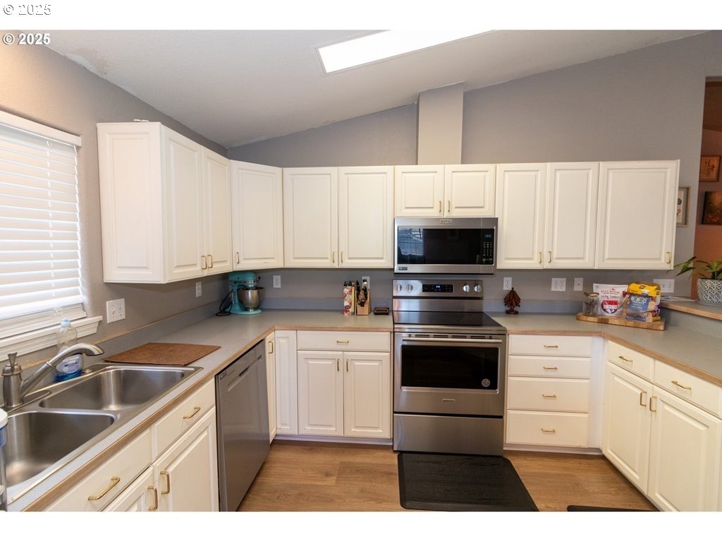 35 Wildwinds Street Florence, OR 97439 - Photo 11 of 32 a kitchen with stainless steel appliances a stove a sink and a microwave