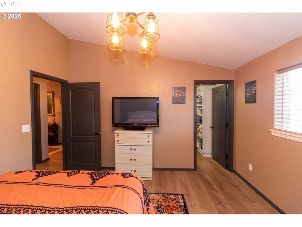35 Wildwinds Street Florence, OR 97439 - Photo 15 of 32 a bedroom with a bed and a flat tv screen on dresser