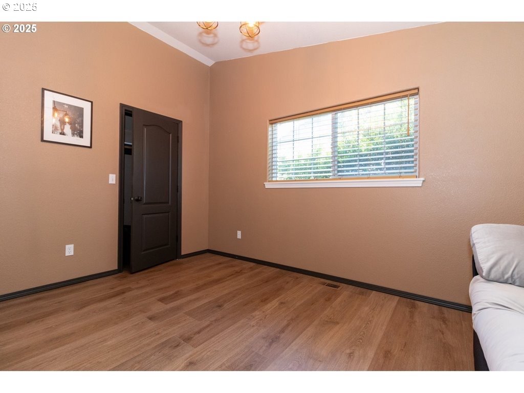 35 Wildwinds Street Florence, OR 97439 - Photo 18 of 32 a view of an empty room with wooden floor and a window