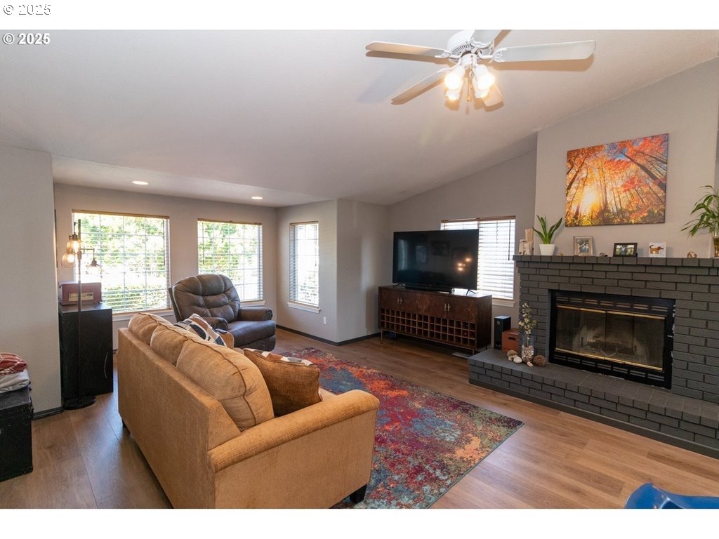 35 Wildwinds Street Florence, OR 97439 - Photo 4 of 32 a living room with furniture a flat screen tv and a fireplace