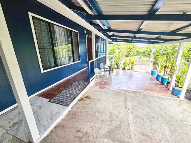 a view of an empty room with a fireplace and windows