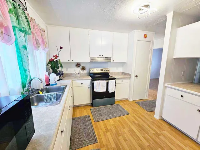 a kitchen with stainless steel appliances a stove a sink and a refrigerator