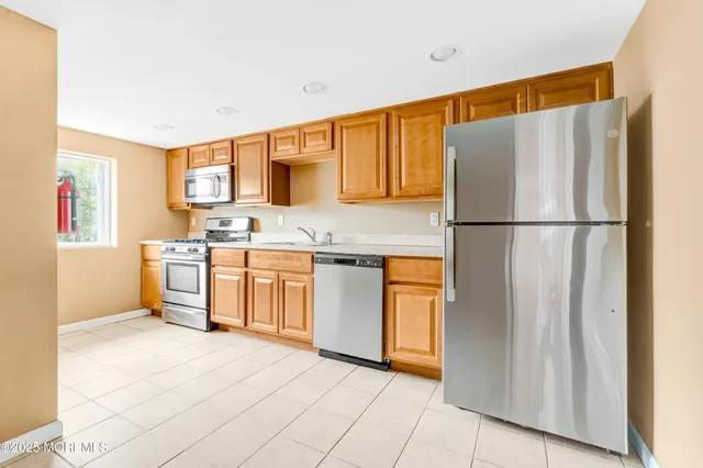 a kitchen with stainless steel appliances granite countertop a stove and a microwave