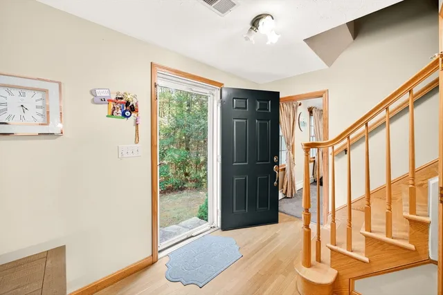 a view of an entryway with wooden floor
